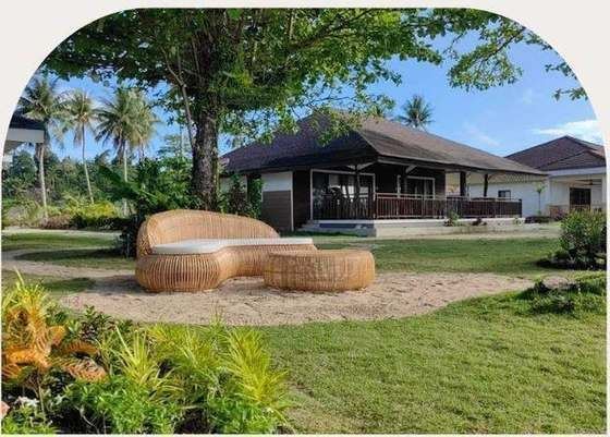A Hibla daybed and ottoman on the lawn in General Luna
